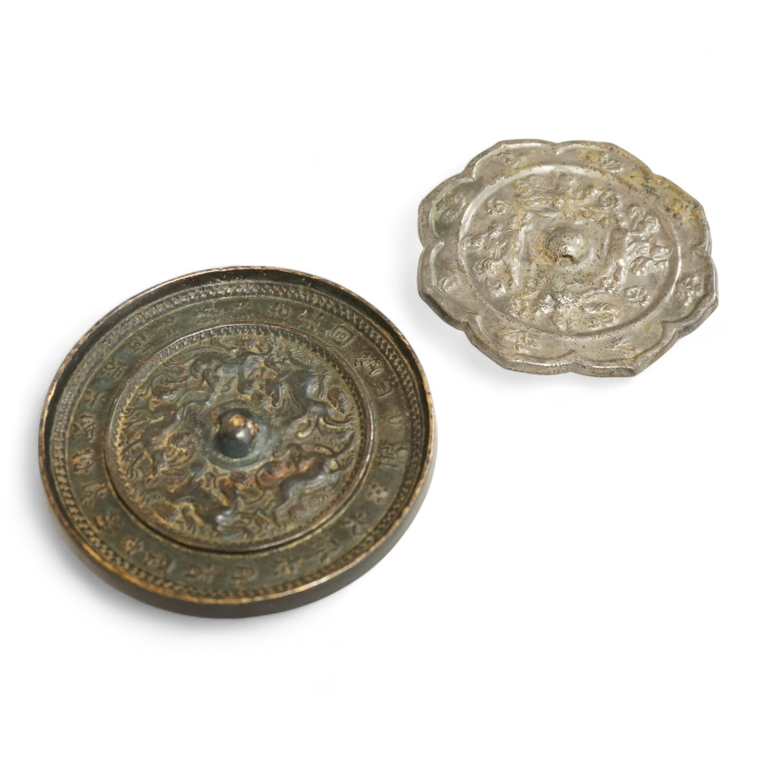 Two Chinese metal hand-mirrors, largest 13cm